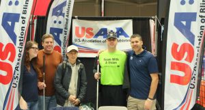 Team With A Vision members in front of a USABA banner at the California International Marathon 2014 Expo