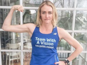 Heather B. Armstrong posing in a Team With A Vision shirt while flexing her bicep